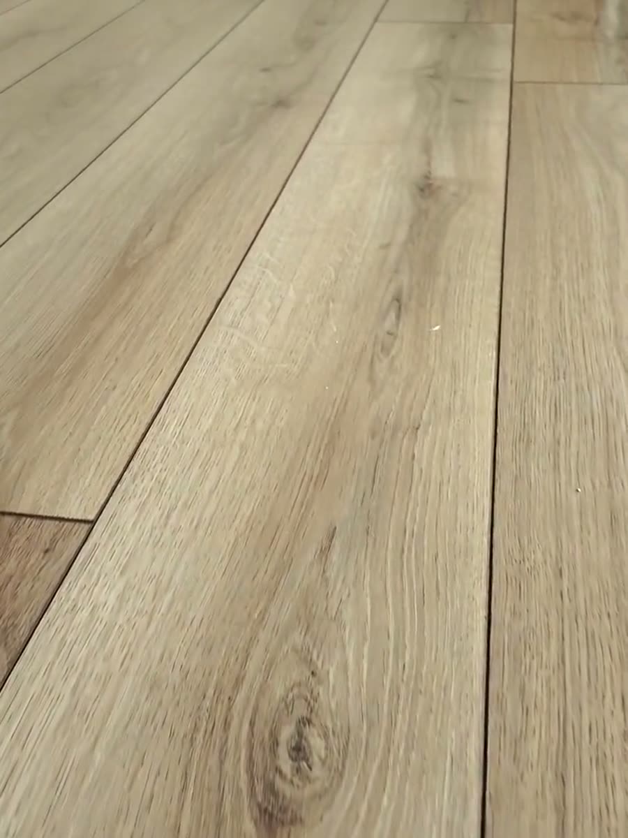 Wide oak-look planks laid in a run with the joints closed tight