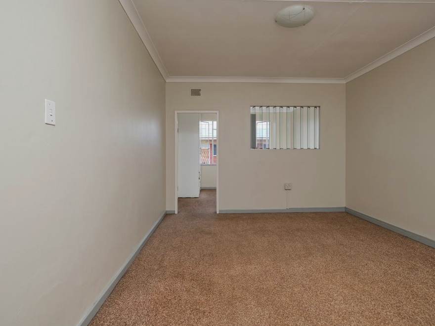 Empty upstairs room laid with carpet