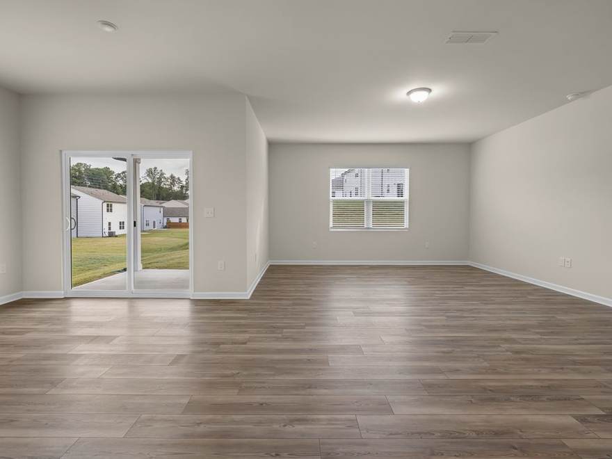 Open living area on a grey plank floor