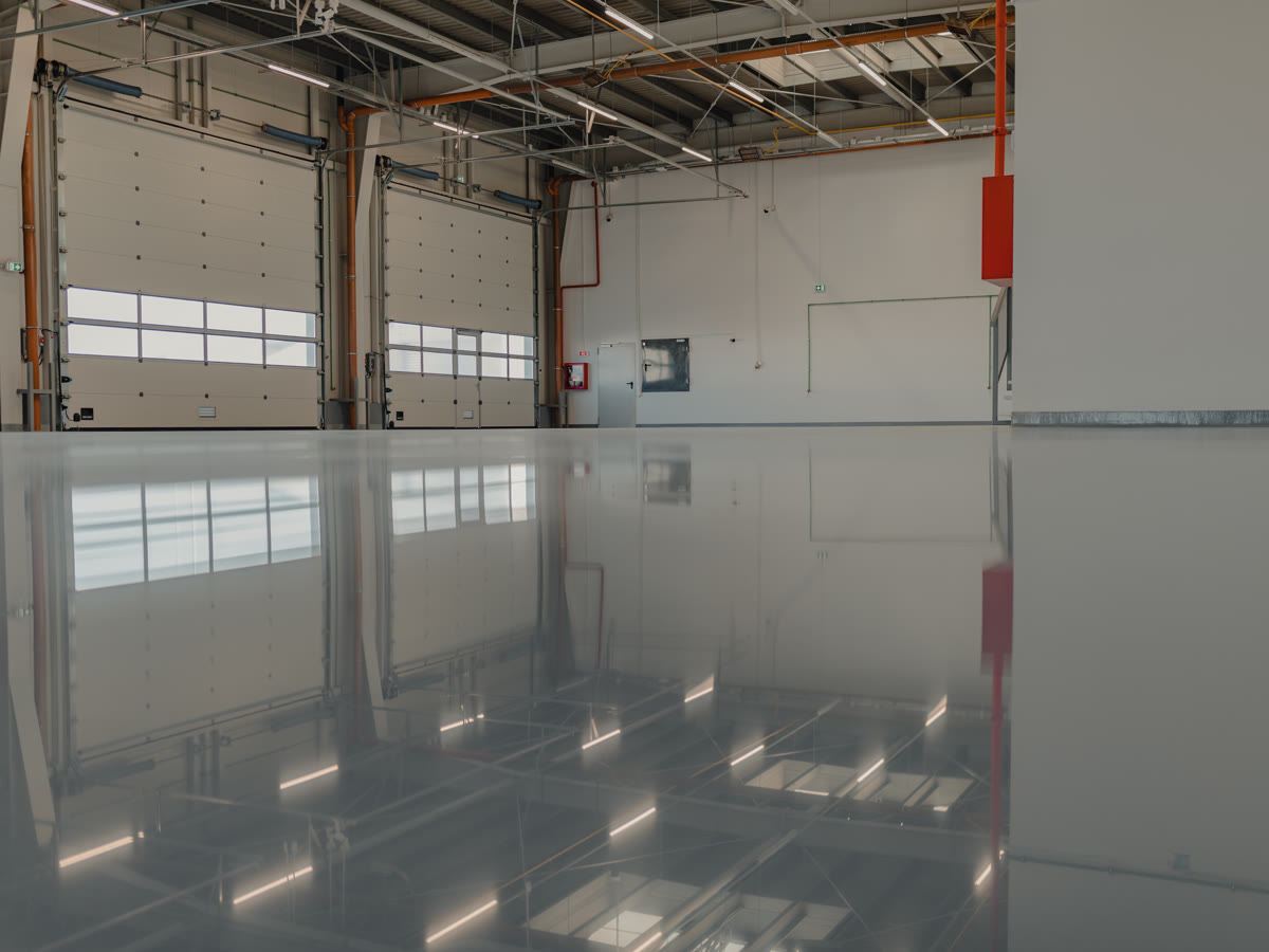 Reflective grey resin floor in an industrial unit