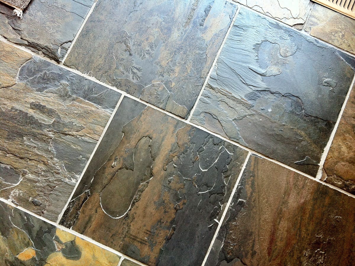 Slate floor tiles in mixed grey, rust and ochre tones