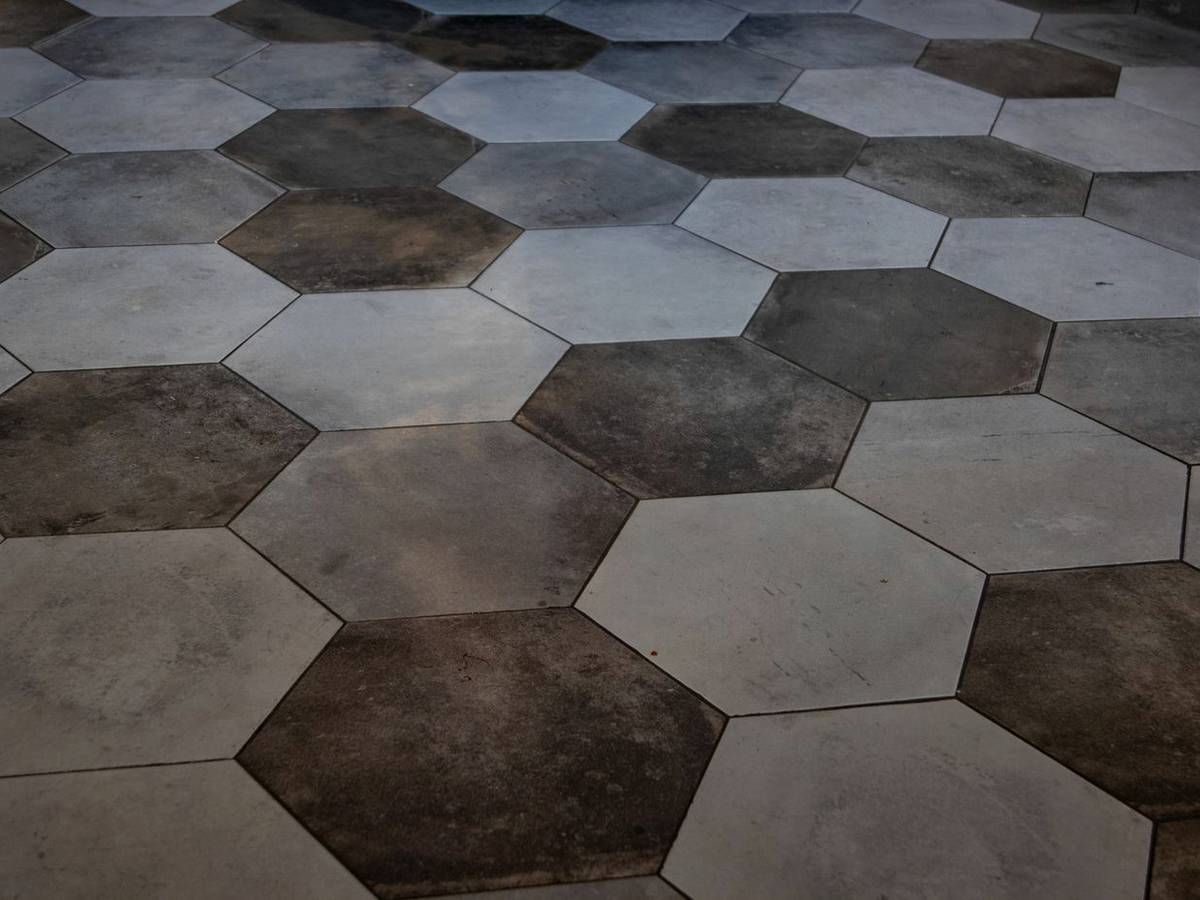 Hexagonal stone floor tiles in warm grey and brown
