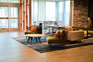 Hotel lobby lounge with wood-look plank flooring and area rug